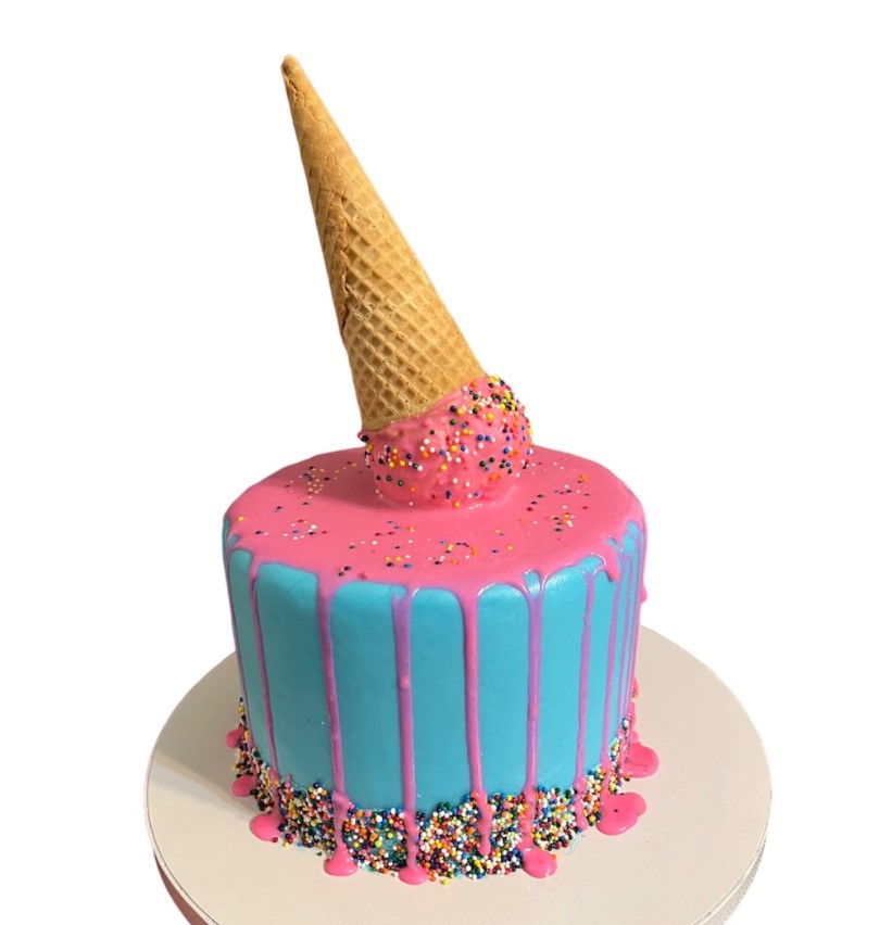 Playful ice cream cone themed cake with turquoise frosting, pink drip, and rainbow sprinkles