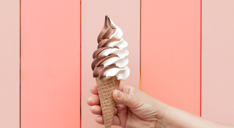 Swirled soft serve ice cream in a classic cone